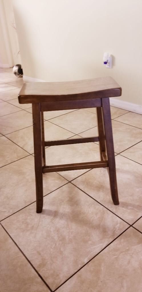 Brown dining table with built in wine rack and chairs