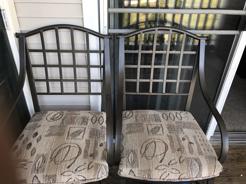 Two solid cast iron patio chair.