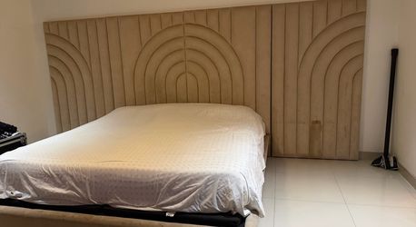 large custom/designer upholstered wall headboard with a matching bed frame, headboard