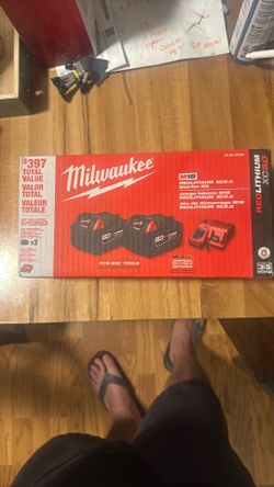 Two 5 Hour Milwaukee Batteries And Charger