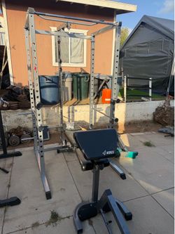 Power rack with pulley and adjustable bench