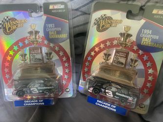 two Winner's Circle 1:64 scale NASCAR diecast car sets from the "Decade of Champions" series, released around 2003