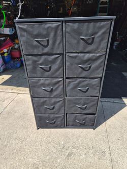 Tall dresser with fabric drawers.
