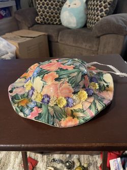 This ceramic piece is a decorative vintage-style wall hanging bonnet, a collectible item typically created by artists like Linda Edgington.