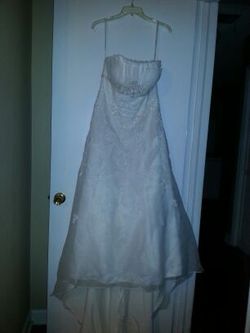 Wedding dress ivory size 14. Comes with veil and slip for $450.00