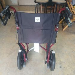 Medline Lightweight Foldable Transport Wheelchair with Handbrakes and 12-Inch Wheels, Red Frame, Black Upholstery