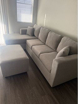 Brand new grey sectionals with free ottoman ( happy customer)