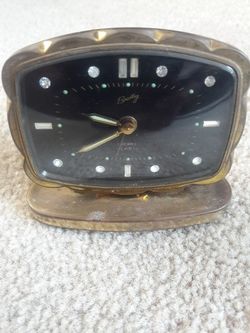 Antique wind-up glow alarm clock