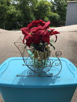 Golden wire plant holder with a Poinsettia plant