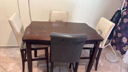 Dinner table with beige chair and brown chair