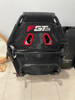 gaming chair with logitech steering wheel, pedals, and shifter