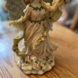 Angel figurine music box plays hark The Herald Angels Sing