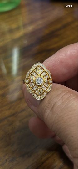 18k ladies Ring with . 35 carat natural diamond center with small diamond sorrounding size 5 pick up only!!