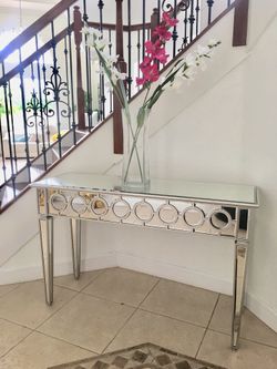 Table mirror and glass vase with flowers