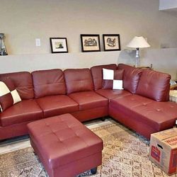 Red leather sectional couch and ottoman