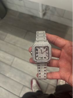 This is a Cartier Santos style watch, fully iced out with moissanite diamonds on the bezel and bracelet.