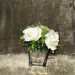 small artificial flower arrangement in a glass vase