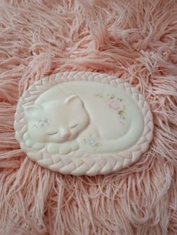 Sculpted cat on a rug wall hanging