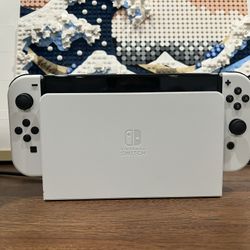 Nintendo Switch OLED (White) - $280 - Includes 4 Games + Accessories