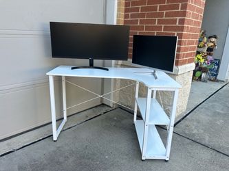 L-shaped computer desk with built-in lower storage shelves and a metal frame