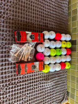 33 used mixed use golf balls and tees
