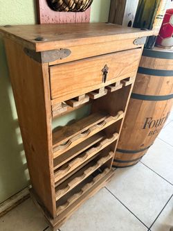 Mexican pine wine rack, which is a rustic, freestanding wooden unit
