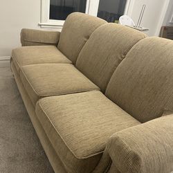 Tan couch with accent chair and ottoman