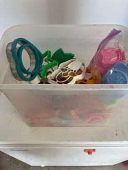 Container of assorted cookie cutters and molds