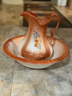 Vintage-style ironstone wash basin and pitcher set with floral accents.