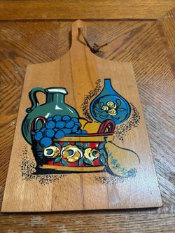 vintage hand-painted wooden cutting board with a colorful fruit pattern.