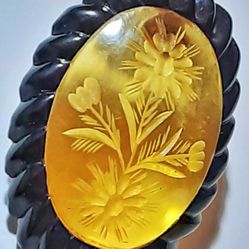 Art deco carved apple juice bakelite dress clip with black bakelite faux rope border