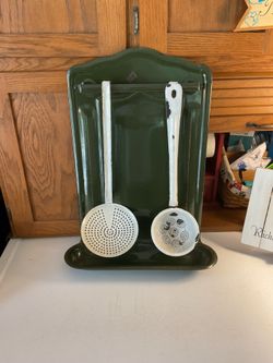 Vintage green, enamelware kitchen, utensil rack with white ladle and strainer