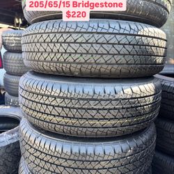 FOUR GOOD USED TIRES 95%TREAD LIFE.  205/65/15 BRIGESTONE DULER 