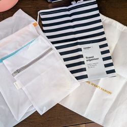 Set of 3 mesh zippered bags ($5) and two laundry washable drawstring bags ($2 - $3)