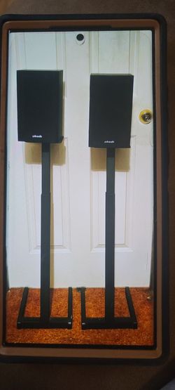 POLK AUDIO  SURROUND SOUND SPEAKERS (ON ADJUSTABLE STANDS).
