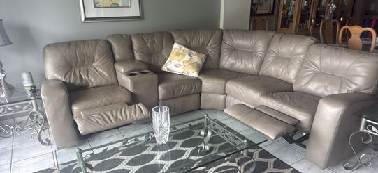 Grey sectional leather couch with two recliners and storage