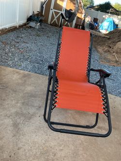 A beautiful , long , orange relax chair