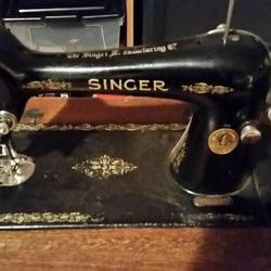 Antique singer 99-13 sewing machine with cabinet, manual and accessories. $150