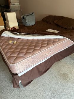 Queen size bed with frame and mattress.