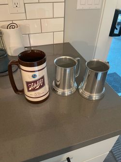 Vintage Schlitz Beer mugs from the 1970’s in very good condition - 1 tall plastic and 2 Aluminum ones with saying on bottom