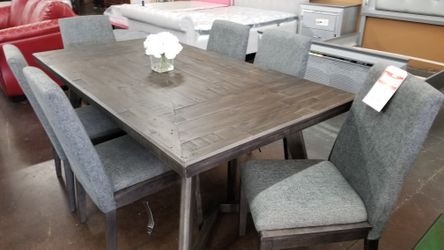 Top of the line antique rustic finish table and 6 upholstered chairs from Ashley