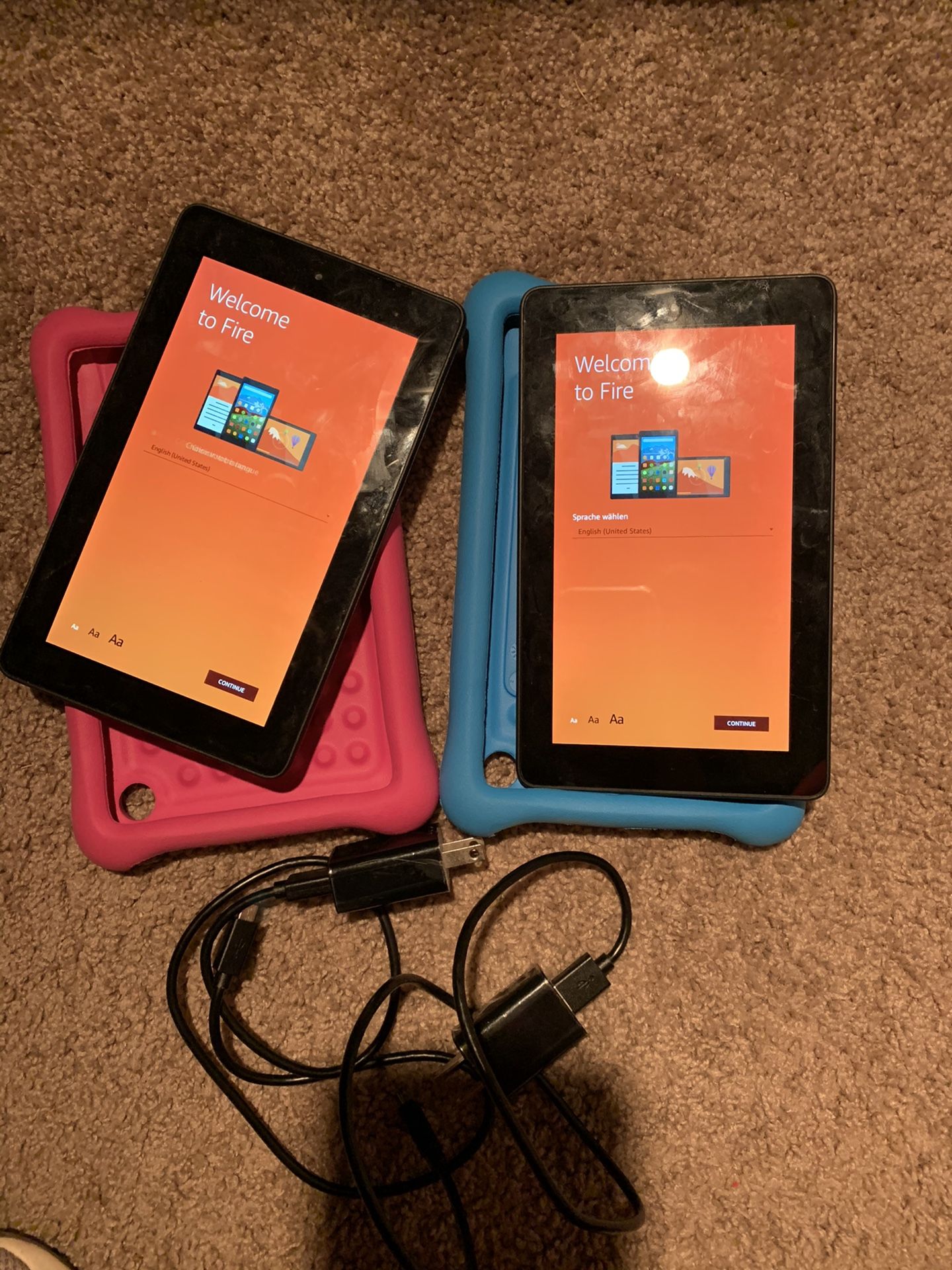 2 Amazon Fire tablets with case (1 blue & 1 pink) and 2 chargers