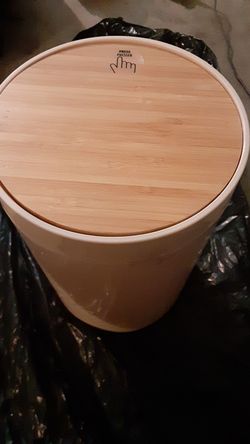 Trash/storage container with wooden swivel lid