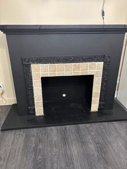 Beautiful black wood fireplace with stone tile