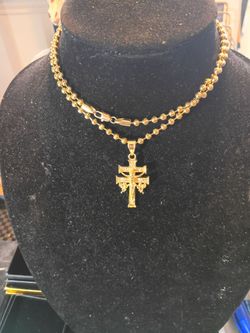 Gold tone chain with balls on it 27" long was gold tone cross with Jesus Christ and angels on it 2