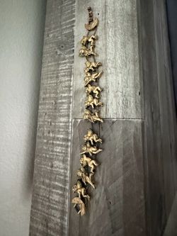 vintage gold-toned brass statement bracelet features numerous cherub links