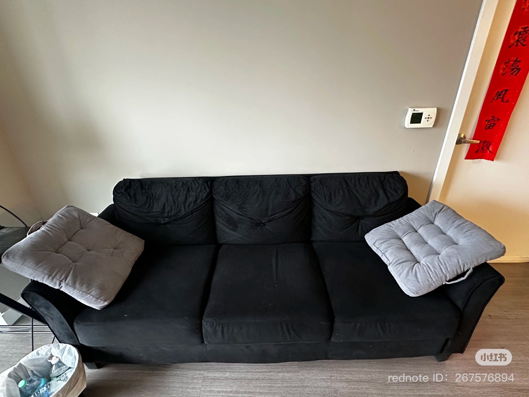 three-seater black sofa