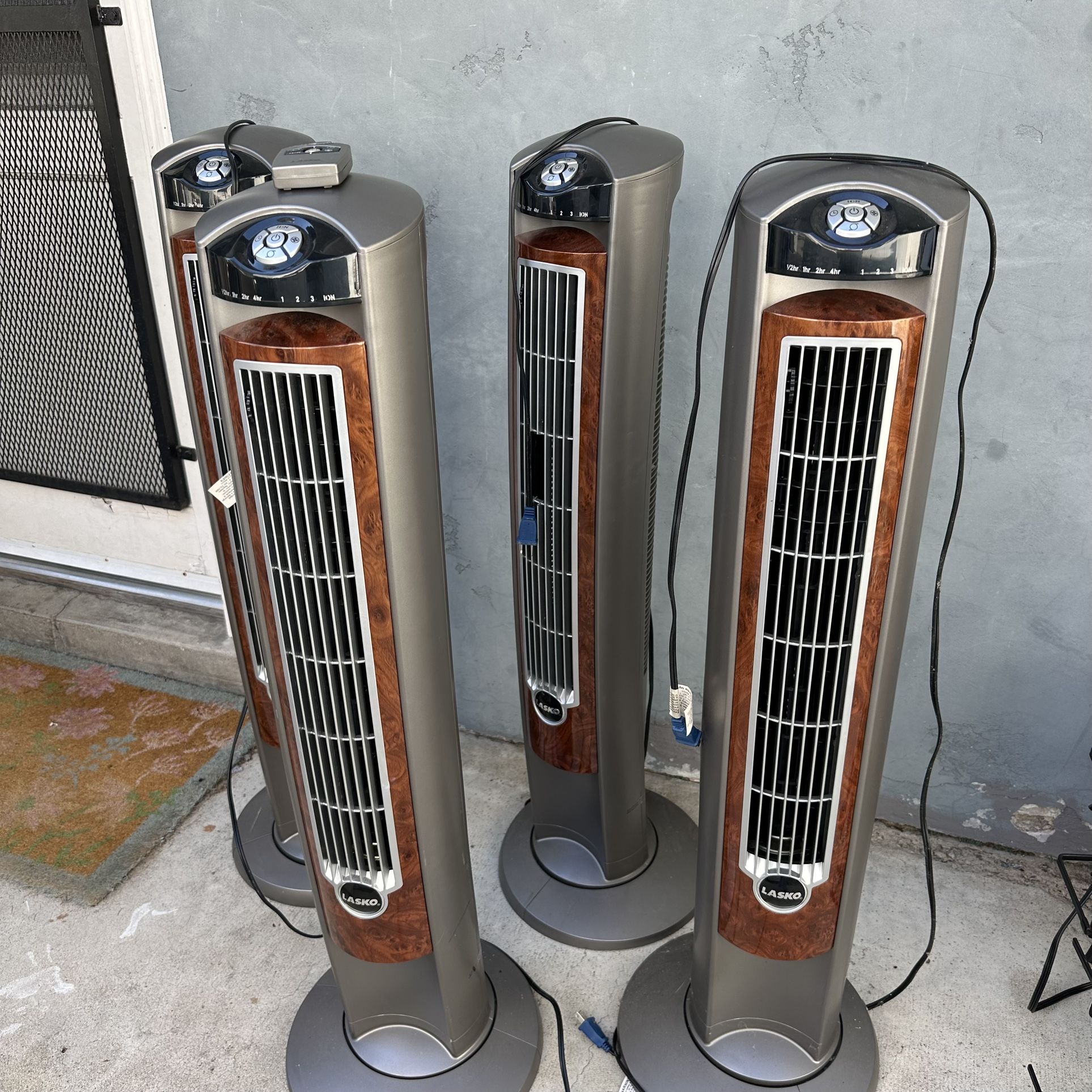 2 Oscillating Tower Fans With Remotes By Lasko
