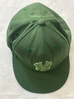 Green New York Yankees baseball cap, commonly found in styles such as the New Era 59FIFTY fitted hat or an adjustable branded cap.    Green New York Y