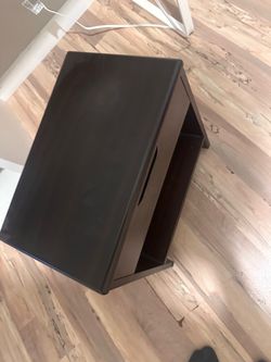 Small bedside table with a top-opening lid.